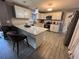 Well-equipped kitchen with white cabinets, marbled countertops, and modern appliances at 307 N Oak Ave, Fort Meade, FL 33841