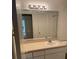 This bathroom features a large mirror over a vanity with white cabinets and a single sink at 325 Wymore Rd # 203, Altamonte Springs, FL 32714