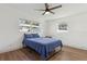 Bedroom with light wood floors, a ceiling fan, and natural light from two windows at 3632 E Kaley Ave, Orlando, FL 32812