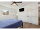 Bright bedroom featuring a ceiling fan, TV, and natural light from the window at 3632 E Kaley Ave, Orlando, FL 32812