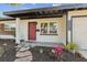 Eye-catching red front door and landscaped entry complement this charming single-story home at 3632 E Kaley Ave, Orlando, FL 32812