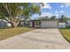 This single-story home with front lawn features brick accents and an attached garage at 3632 E Kaley Ave, Orlando, FL 32812