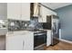 Beautiful kitchen featuring stainless steel appliances, sleek white cabinetry, and modern backsplash at 3632 E Kaley Ave, Orlando, FL 32812