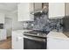 Modern kitchen with stainless steel oven, white cabinets, and eye-catching tile backsplash at 3632 E Kaley Ave, Orlando, FL 32812