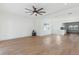 Large living room featuring light wood floors, a ceiling fan, recessed lights and access to the kitchen at 3632 E Kaley Ave, Orlando, FL 32812