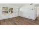 Inviting living area with wood-look flooring, a bright window, and a modern front entry door at 3632 E Kaley Ave, Orlando, FL 32812