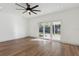 Open living room with light wood floors, ceiling fan, recessed lighting, and sliding glass doors to the backyard at 3632 E Kaley Ave, Orlando, FL 32812