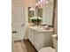 Cozy bathroom with a vanity, mirror and white cabinets offers storage at 382 Raleigh Pl, Oviedo, FL 32765