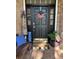 Front door decorated with patriotic decor, wreath, bench, and flower pot at 382 Raleigh Pl, Oviedo, FL 32765