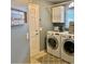 Laundry room with modern appliances and light blue walls and gray rug at 382 Raleigh Pl, Oviedo, FL 32765