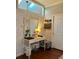 Stylish vanity area featuring a brick wall, skylight, and decorative mirror at 382 Raleigh Pl, Oviedo, FL 32765