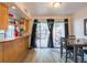 Well-lit dining area with a sliding glass door to the backyard, next to an open kitchen layout at 4004 Barwood Dr # 3804, Orlando, FL 32839