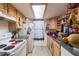 Well-lit kitchen featuring functional appliances, wooden cabinets, and a skylight at 4004 Barwood Dr # 3804, Orlando, FL 32839