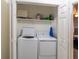 Convenient laundry closet with washer, dryer, and shelving for storage at 4004 Barwood Dr # 3804, Orlando, FL 32839