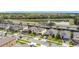 Community aerial shot showing houses with neat landscaping and a tranquil pond in background at 5311 Brydon Woods Cir, St Cloud, FL 34771