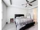 Bedroom with a black bed frame, tray ceiling with ceiling fan, gray floors, and an ensuite bathroom at 5311 Brydon Woods Cir, St Cloud, FL 34771