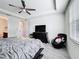 Bedroom with a black dresser, tray ceiling with ceiling fan, and gray wood floors at 5311 Brydon Woods Cir, St Cloud, FL 34771