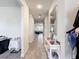 Bright hallway featuring wood-look tile flooring, complemented by neutral walls and an elegant accent mirror at 5311 Brydon Woods Cir, St Cloud, FL 34771