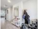 Bright hallway featuring wood-look tile flooring, complemented by neutral walls and an elegant accent mirror at 5311 Brydon Woods Cir, St Cloud, FL 34771