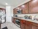 Modern kitchen featuring stainless steel appliances, granite countertops, and ample cabinet space at 5311 Brydon Woods Cir, St Cloud, FL 34771