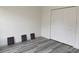 Minimalist bedroom with wood-look flooring, large closet and motivational art at 538 Marion Oaks Blvd, Ocala, FL 34473