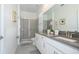 Elegant bathroom featuring double sinks, a large mirror, sleek countertops, and a glass-enclosed shower at 540 Sticks St, Davenport, FL 33896