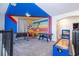 Fun game room featuring foosball, air hockey, and vibrant Mickey Mouse decor for entertainment at 540 Sticks St, Davenport, FL 33896