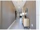 Inviting hallway with neutral tones, modern lighting, and a glimpse into the living area at 540 Sticks St, Davenport, FL 33896