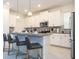 Well-equipped kitchen island with bar stool seating, and white cabinets at 540 Sticks St, Davenport, FL 33896