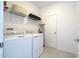 Bright laundry room with modern appliances, storage shelves, and a clean, functional design at 540 Sticks St, Davenport, FL 33896