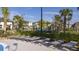 Community pool deck with gray cushioned lounge chairs and palm tree landscaping at 540 Sticks St, Davenport, FL 33896