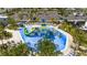 Aerial view of the community splash pad featuring slides, overhead buckets, and blue cushioned flooring at 540 Sticks St, Davenport, FL 33896