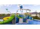 Community splash pad featuring slides, overhead buckets, and blue cushioned flooring at 540 Sticks St, Davenport, FL 33896