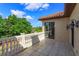 Balcony with tiled floors and white railings overlooking a lush green landscape at 5719 Emerson Pointe Way, Orlando, FL 32819