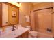 Charming bathroom with a shower-tub combo, a wood vanity and a decorative mirror at 5719 Emerson Pointe Way, Orlando, FL 32819