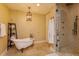 Elegant bathroom featuring a freestanding tub, chandelier, and a separate walk-in shower at 5719 Emerson Pointe Way, Orlando, FL 32819