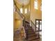 Grand foyer with a curved staircase, iron railing, and a decorative front door at 5719 Emerson Pointe Way, Orlando, FL 32819