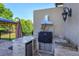 An elegant outdoor kitchen featuring stone countertops, stainless steel appliances, and a built-in grill at 5719 Emerson Pointe Way, Orlando, FL 32819