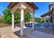 Outdoor living is epitomized by a gorgeous pool pavilion with stone floors and white pillars at 5719 Emerson Pointe Way, Orlando, FL 32819