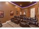 Home theater room with tiered seating, leather recliners, and a dark-colored ceiling at 5719 Emerson Pointe Way, Orlando, FL 32819