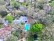 An aerial view showcases the backyard, pool and privacy offered by the surrounding mature trees at 621 Daron Ct, Winter Springs, FL 32708