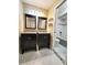 Bathroom featuring double vanities with granite counters, tile flooring, and a tiled tub/shower combination at 621 Daron Ct, Winter Springs, FL 32708