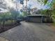 Spacious home with a two-car garage and a paved driveway surrounded by mature trees and landscaping at 621 Daron Ct, Winter Springs, FL 32708