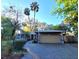 Charming single-story home featuring a two-car garage, blue facade, and meticulous landscaping at 621 Daron Ct, Winter Springs, FL 32708