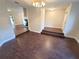 Open-concept living area featuring wood-look floors, a chandelier, and steps to a fireplace and living area at 621 Daron Ct, Winter Springs, FL 32708