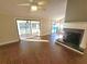 Open living room with fireplace, ceiling fan and sliding glass doors to the porch and pool area at 621 Daron Ct, Winter Springs, FL 32708