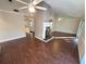 Open living room with hard floors, ceiling fan and fireplace at 621 Daron Ct, Winter Springs, FL 32708