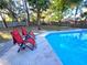 Pool and lounge area with red lounge chairs at 621 Daron Ct, Winter Springs, FL 32708