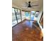 A sun room overlooking the pool with tile floor, ceiling fan, and large windows at 621 Daron Ct, Winter Springs, FL 32708