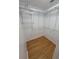 A walk-in closet with custom metal shelving and wood floor at 621 Daron Ct, Winter Springs, FL 32708